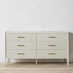 a white dresser sitting on top of a hard wood floor