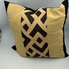 a black and yellow pillow sitting on top of a table