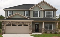 a large house with two garages in the front and one on the other side