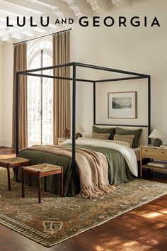 King size canopy bedframe made from  poplar, plywood, rubber wood and oak veneer atop a traditional style rug. Canopy Bed Nightstands, Black Post Bed Frame, Black Frame Canopy Bed, Black King Canopy Bed, Farmhouse Canopy Bed Pottery Barn, Black Wood Canopy Bed, Canopy Bed Interior Design, Cozy Bedroom Canopy Bed, Moody Bedroom Four Poster Bed