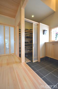 an empty walk in closet next to a tiled floor