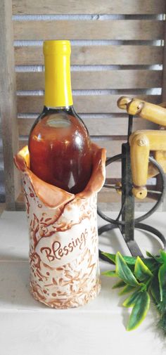 a bottle of ketchup sitting on top of a table next to a plant