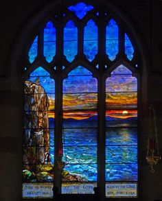 a stained glass window in the front of a church with an ocean scene on it