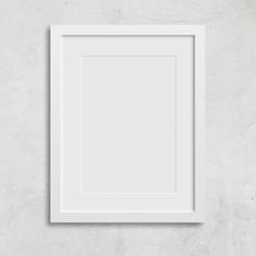 an empty white frame hanging on the wall