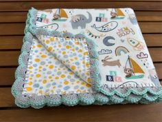 a baby blanket on top of a wooden table