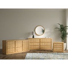 an empty room with a large wooden dresser and mirror on the wall next to a potted plant