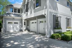 a large white house with two garages