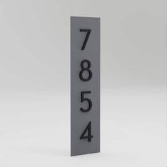 a black and white sign with numbers on it's side, in front of a gray background