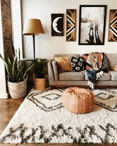 a living room filled with lots of furniture and pictures on the wall above it's couch