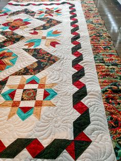 a quilted table runner is on the floor