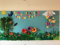 the wall is decorated with paper flowers and butterflies