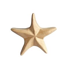 a wooden star ornament on a white background