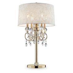 a table lamp with a white shade and crystal beads on the bottom, in an ornate design