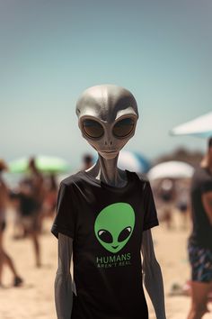 an alien wearing a t - shirt with the words humans aren't aliens on it