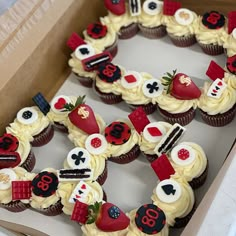 cupcakes arranged in the shape of a heart with numbers and symbols on them