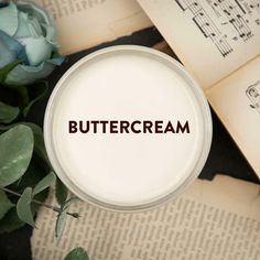 the word buttercream is placed on top of an open book next to flowers