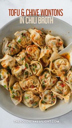 a white bowl filled with tortilla shells and sauce on top of a marble counter