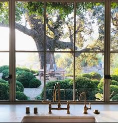 a kitchen with a large window looking out onto the yard