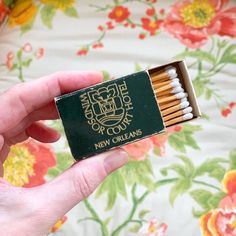 a person holding a match box with matches in it