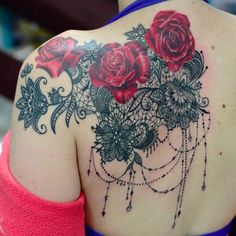 the back of a woman's shoulder with roses on it