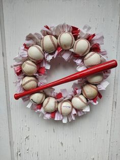 a wreath with baseballs and a bat on it