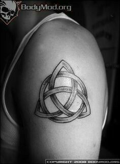 a black and white photo of a celtic tattoo