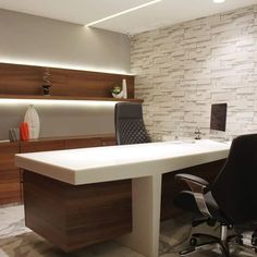 an office with a white desk and black chairs