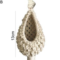 a crocheted cat toy hanging from a white pole with measurements for the size