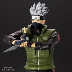 the action figure is holding a knife and wearing a green jacket with black gloves on it