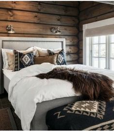 a large bed sitting next to a window in a bedroom