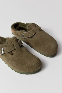 So cozy we can't believe these suede clogs from Birkenstock. The coziest clog around with a soft suede upper lined in fluffy shearling with an adjustable buckled strap across arch and a cushy EVA sole. Content + Care Suede, shearling, EVA Spot clean Imported Size All sizes in narrow width | Birkenstock Boston Shearling Clog in Thyme at Urban Outfitters Winter Suede Clogs With Textured Footbed, Casual Sheepskin Slip-on Clogs, Winter Clogs With Suede Lining And Comfortable Style, Winter Comfortable Clogs With Suede Lining, Winter Slip-on Suede Clogs, Winter Clogs With Suede Lining, Winter Suede Slip-on Clogs, Winter Suede Clogs, Winter Suede Clogs With Leather Footbed