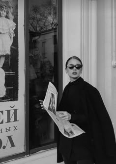 black and white photograph of a woman reading a newspaper