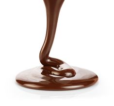 the chocolate sauce is being poured on top of the liquid that's pouring out of it