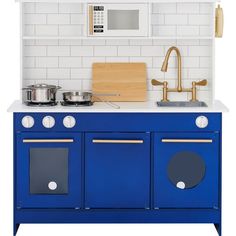 a blue stove top oven sitting inside of a kitchen