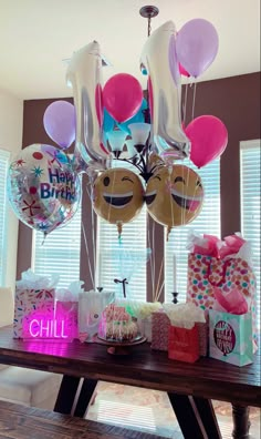 a table with balloons and presents on it