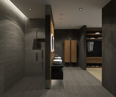 a modern bathroom is shown with grey walls and flooring, along with dark wood cabinetry