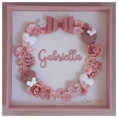 a pink frame with flowers and bows around it that says gabrillia in the center