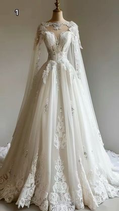 a white wedding dress with long sleeves and laces on the skirt is displayed in front of