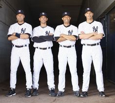 three baseball players are posing for a photo