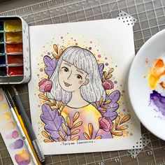 a watercolor and ink drawing of a girl with flowers in her hair, surrounded by paintbrushes