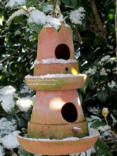 a bird house made out of watermelon with snow on the top and bottom