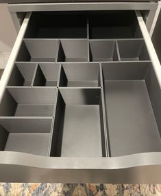 an open drawer with compartments in it