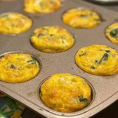 several muffins in a metal pan on top of a table