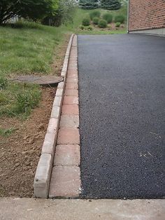 a red fire hydrant sitting on the side of a road next to a sidewalk