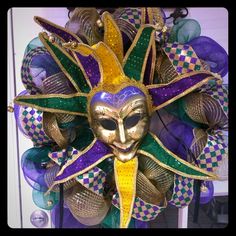 a mardi gras mask hanging on the front door