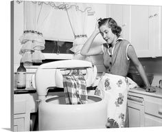 a woman washing her hands in the kitchen sink