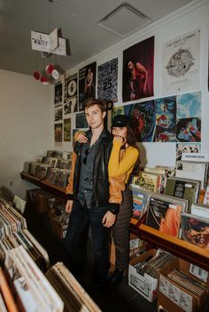 a man and woman standing in front of records