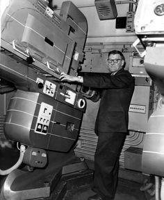 a man standing next to a machine in a room