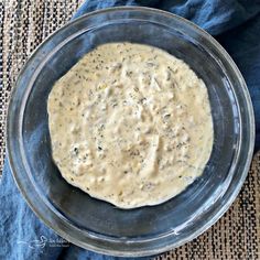 a bowl filled with batter sitting on top of a blue cloth