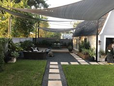 an outdoor patio with lots of grass and plants